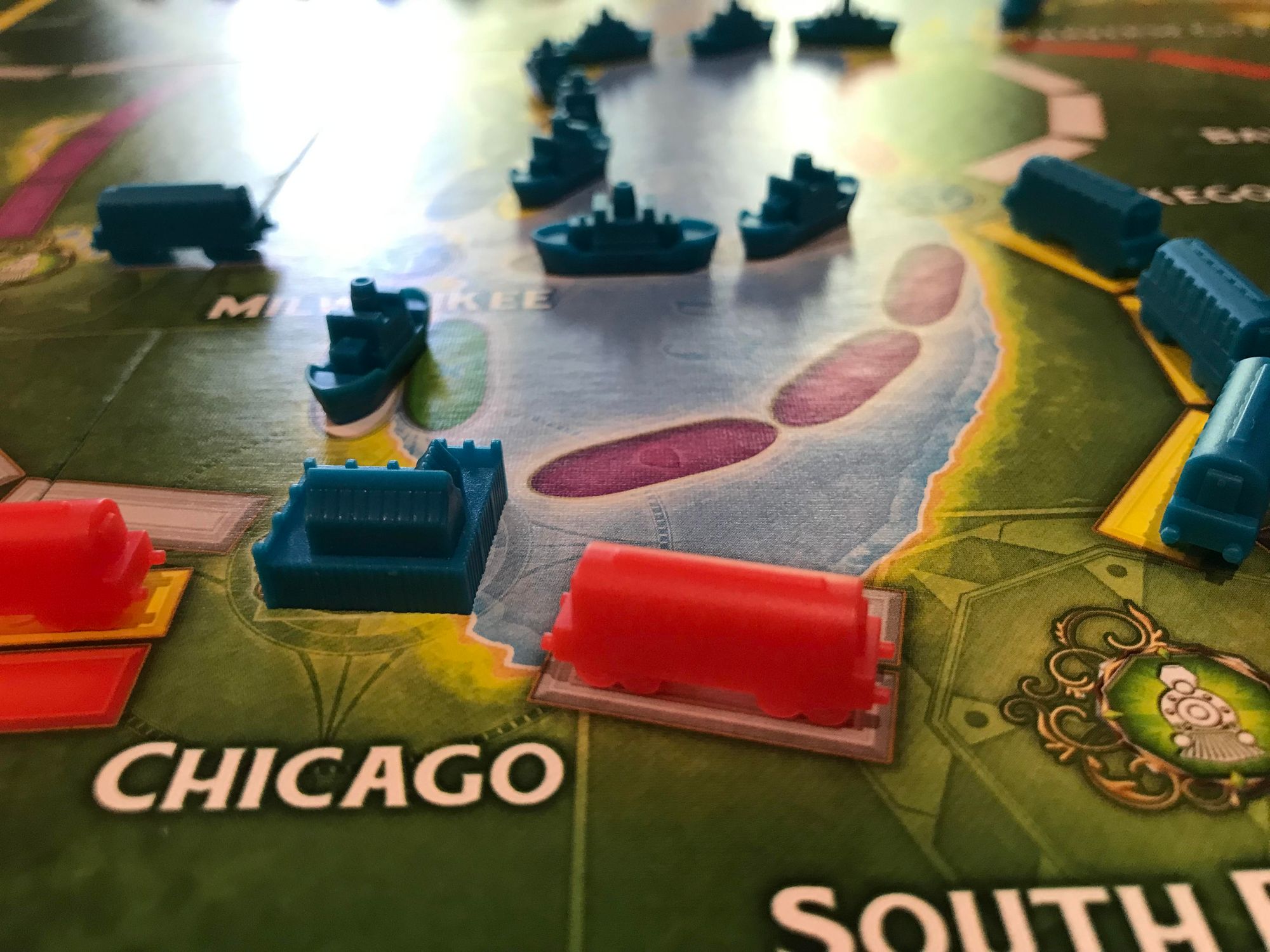 Board game showing a map with Chicago and game pieces of trains and ships.