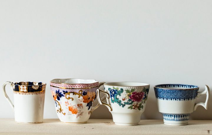 Row of four mismatched teacups.